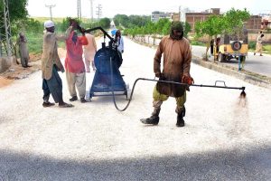 Labourers busy in construction work of New Airport Road during development work in the city