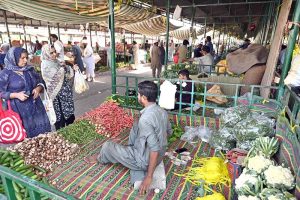 A vendor sells seasonal fruit at his stall in weekly Sunday Bazaar in G-6 Sector in the Federal Capital
