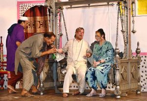 Artists are performing on stage during the drama "Kachi Mitti Ke Log" at the Sargodha Arts Council, in collaboration with Burhan City.