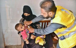 A health worker busy in administering polio drops to child during anti polio campaign in Bhitai Hospital at Latifabad.
