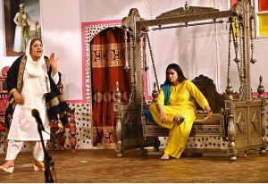 Artists are performing on stage during the drama "Kachi Mitti Ke Log" at the Sargodha Arts Council, in collaboration with Burhan City.