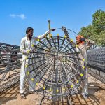 Labourers are busy preparing iron structures for the pillars during the construction of the T-Chowk Flyover, which is part of the ongoing development work