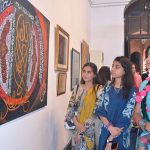 Women art enthusiasts keenly observe masterpieces of artist during a calligraphy exhibition organized to mark Eid Milad-un-Nabi (PBUH) celebrations
