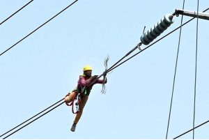 WAPDA staffer is carrying out repair work on the high transmission line, Chauburji.