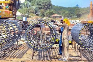 Labourers are busy preparing iron structures for the pillars during the construction of the T-Chowk Flyover, which is part of the ongoing development work