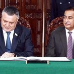 Speaker of the Legislative Chamber of the Oliy Majlis of Uzbekistan, Nuriddin Ismoilov, inscribing his remarks in the visitors’ book at Parliament House