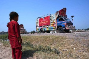 Workers of the Alkhidmat Foundation load relief goods onto delivery trucks in Chamkani to dispatch to flood-affected people in Punjab.