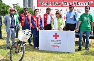Chairperson Pakistan Red Crescent Society (PRCS), Mrs. Farzhana Naek distributing cycles to PRCS volunteer persons during Zero Emission Day "Pedal For The Planet" Cycling Rally at Jinnah Avenue near China Chowk to National Press Club