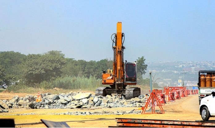 Labourers are busy construction work of the T-Chowk Flyover, which is part of the ongoing development work