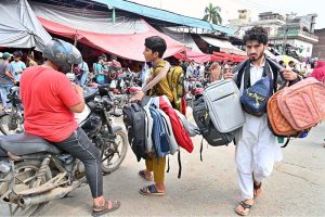 Street vendors displaying bags to attract the customers while shuttling on the road in Provincial Capital