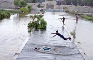 A youngster dives into accumulated rainwater to enjoy swimming at Abbas Bhai Park after heavy showers lashed the city.