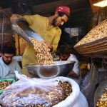 Vendor selling and displaying peanuts to attract the customers at Firdous area.