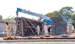 Labourers are busy construction work of the T-Chowk Flyover, which is part of the ongoing development work