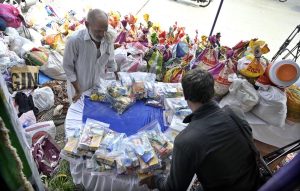 A volunteer arranges donated bags at a donation camp organized by the Pakistan Peoples Party's Islamabad chapter.