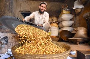Vendor selling and displaying peanuts to attract the customers at Firdous area.