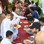 Volunteers serving free food to the participants of the Eid Milad Un Nabi (PBUH) procession at G-7 area in the federal capital