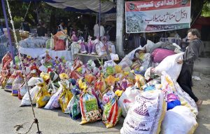 A volunteer arranges donated bags at a donation camp organized by the Pakistan Peoples Party's Islamabad chapter.