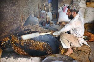 Vendor selling and displaying peanuts to attract the customers at Firdous area.