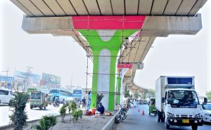 Labourers painting the pillars of a flyover to give it a fresh look and enhance the beauty of the city.
