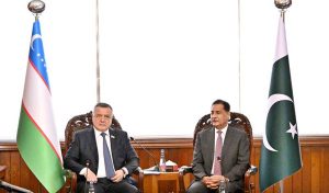 Speaker of the Legislative Chamber of the Oliy Majlis of Uzbekistan, Nuriddin Ismoilov, inscribing his remarks in the visitors’ book at Parliament House