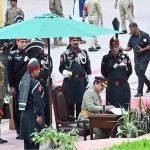 Corps Commander Lahore Lieutenant General Fayyaz Hussain Shah, HI (M), writes his remarks on the book after laying a wreath at Mazar e Iqbal
