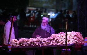 A vendor arranging and displaying different kinds of fruits to attract the customers at Khanna Pul.