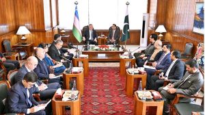 Speaker of the Legislative Chamber of the Oliy Majlis of Uzbekistan, Nuriddin Ismoilov, writing his remarks in the visitors’ book at Parliament House