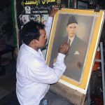 An artist gives final touches to a portrait of Quaid-e-Azam Muhammad Ali Jinnah on his death anniversary