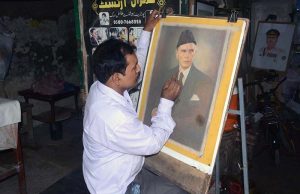 An artist gives final touches to a portrait of Quaid-e-Azam Muhammad Ali Jinnah on his death anniversary