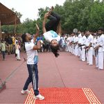 Children perform gymnastics during the Eid Milad-un-Nabi celebration procession at the Railway Station