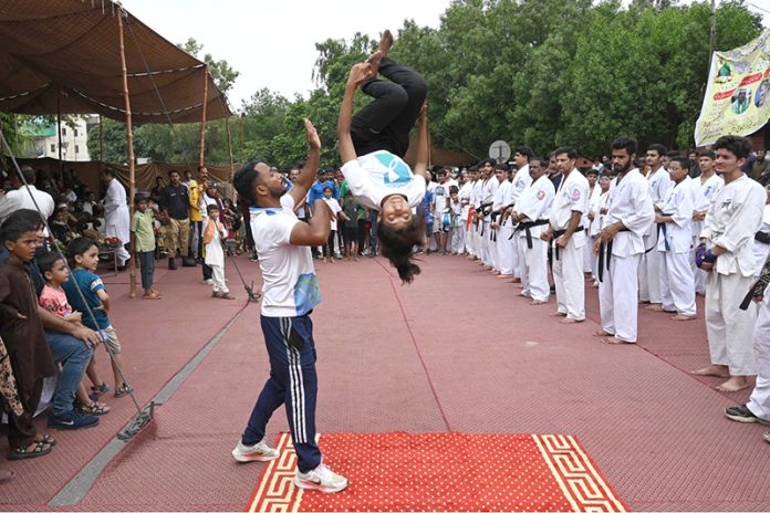 Children perform gymnastics during the Eid Milad-un-Nabi celebration procession at the Railway Station