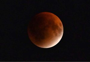 A view of lunar eclipse observe in the city. A lunar eclipse occurs when the Earth comes directly between the Sun and the Moon, casting its shadow across the lunar surface