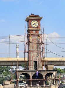 Labourers are busy with the renovation work on the clock tower at Rehman Abad.
