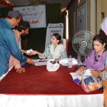 Flood-affected being registered during the distribution ceremony of essential relief packages among flood-affected families of Union Council Sher Shah organized by farmer development organization, collaboration with the Pakistan poverty Alleviation fund at a local hall