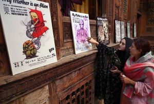 Female visitors take interest in display posters during the exhibition “My Mother is an Alien”, organized in collaboration with Shaheed Benazir Bhutto Women University, Pakistan curator of 6vi, and event organizer Abiha Mahdia at the historic Sethi House.