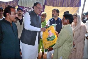 Federal Minister for Finance and Revenue Senator Muhammad Aurangzeb is distributing ration among the flood-stricken families during his visit to Ration Distribution Center.