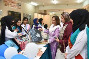 Principal Prof. Rozina Faheem along with students visiting a stall at the 2nd International Seerat Festival, Book Fair and Islamic Calligraphy Exhibition held at FG Home Economics College F-11/1.