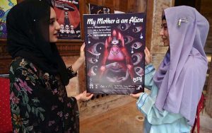 Female visitors take interest in display posters during the exhibition “My Mother is an Alien”, organized in collaboration with Shaheed Benazir Bhutto Women University, Pakistan curator of 6vi, and event organizer Abiha Mahdia at the historic Sethi House.