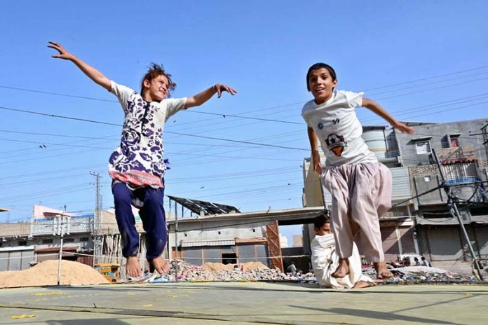 Children enjoying on jumping-jack at Sadeeqi Colony
