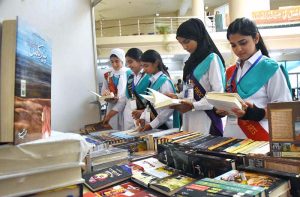 Principal Prof. Rozina Faheem along with students visiting a stall at the 2nd International Seerat Festival, Book Fair and Islamic Calligraphy Exhibition held at FG Home Economics College F-11/1.