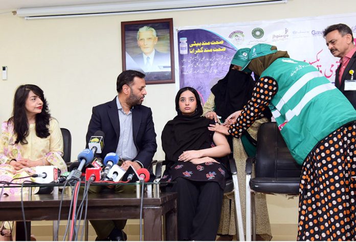 Lady Health Workers administering an HPV vaccine to the daughter of Federal Health Minister, Syed Mustafa Kamal, at the DRAP Office as part of efforts to counter propaganda against vaccination