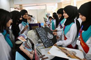 Principal Prof. Rozina Faheem along with students visiting a stall at the 2nd International Seerat Festival, Book Fair and Islamic Calligraphy Exhibition held at FG Home Economics College F-11/1.