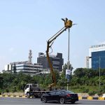 An IESCO worker restores a street light along Srinagar Highway, ensuring brighter nights for commuters in the Federal Capital