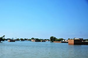 A boat carrying residents evacuated people from flooded areas after rising river water submerged villages.