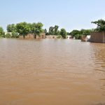 A view of submerged houses as floodwaters inundate several villages