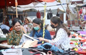 Women browse second-hand branded bags at a market in Saddar, finding affordable luxury in the busiest market of the city.