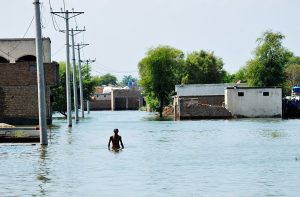 A boat carrying residents evacuated people from flooded areas after rising river water submerged villages.
