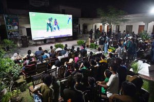 People are watching the live Asia Cup final match between Pakistan and India on big screen outside Niaz Cricket Stadium