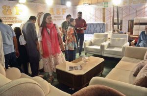 A girl looking at furniture displayed at the Luxury Furniture Brands Expo at Expo Centre.