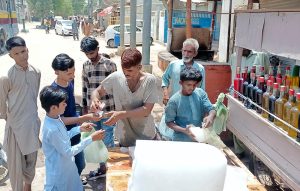 People buying ice due to the intense heat in the city to keep water and drinks cold and get relief from the hot weather.